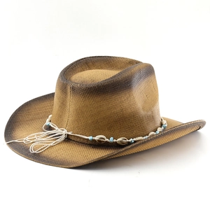 Detail of western straw hat with bohemian beadwork and seashell decoration