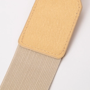 Detail of lychee pattern leather and gold elastic woven strap with fine stitching