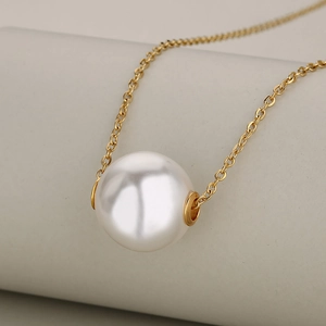 Minimalist gold stainless steel necklace featuring a single round white pearl pendant