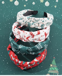 Detailed view of 4 knotted Christmas fabric headbands with festive holiday prints