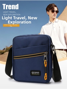 Close-up of navy blue crossbody bag showing fashion sport logo and yellow zipper detail