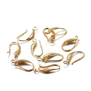 Close-up of golden metal earring hooks with smooth finish for DIY jewelry making