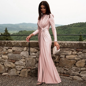Detail of pink satin evening dress featuring a waist knot design and silky fabric