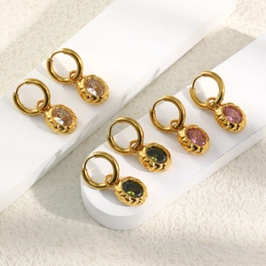 Detailed macro view of 18K gold-plated oval drop earrings with white, pink, and green zircon