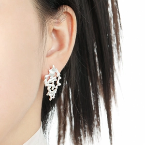 Irregular hollow lava texture silver stud earring made of S925 sterling silver on model