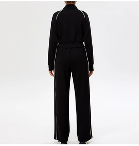 Back view of black and white contrast yoga tracksuit with slim zip jacket and trousers
