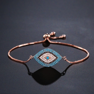 Close-up of rose gold evil eye bracelet with blue and white cubic zirconia crystals