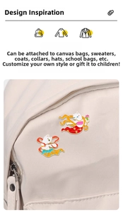 Detailed view of two cute cat enamel pins with Dunhuang cultural style on a canvas bag