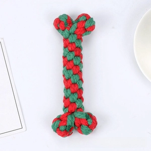 Macro detail of red and green braided cotton rope bone toy for dog dental health