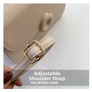 Close-up of adjustable beige leather strap with high-quality golden metal buckle