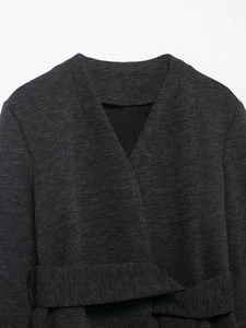 Detail of dark grey long sleeve belted jacket in textured knit fabric with V-neckline