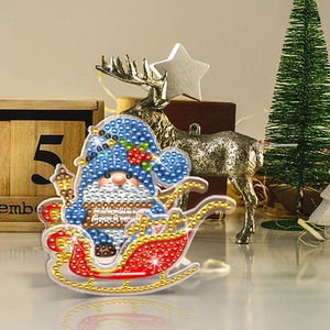 Macro detail of 5D DIY Christmas diamond painting gnome ornament on a red sleigh