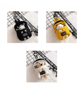 Detail view of mini canvas crossbody chest bags with cute plush animal doll charms
