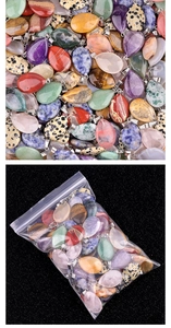 Detailed macro view of assorted natural crystal water drop pendants with silver bails