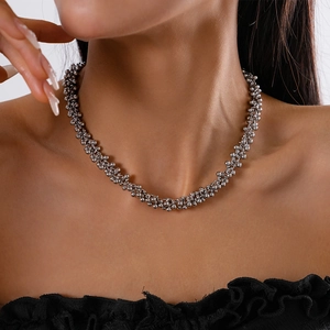 Detailed view of silver metallic beaded choker necklace on model with polished finish