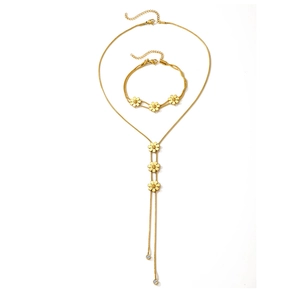 Golden flower jewelry set featuring daisy snake chain necklace and layered bracelet