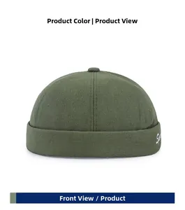 Detail of dark green docker hat featuring white cursive embroidery on cotton twill fabric