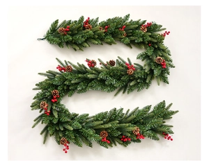 Detail of Christmas garland with pine cones, red berries and snow-dusted green needles