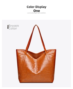 Detailed view of the brown crocodile pattern texture and handle on a large tote bag