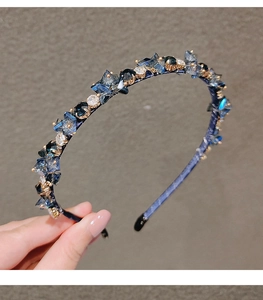 Detail view of handmade luxury headband with dark blue crystals and beaded embellishments