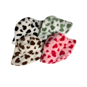 Pink heart-patterned fuzzy bucket hat for women in multiple colors with plush texture