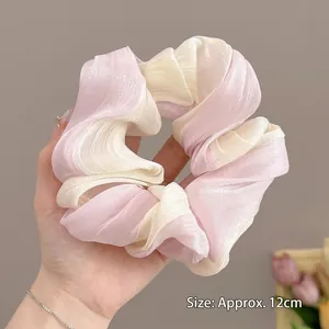 Detail view of pink and white gradient organza scrunchie with 12cm size measurement