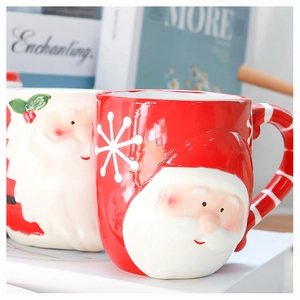 Detailed view of Santa Claus relief on red ceramic mug with striped handle and holiday vibe