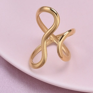 Macro detail of golden abstract curved ring featuring a polished 304 stainless steel surface