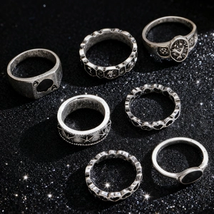 Detail of 7-piece vintage gothic ring set with retro silver finish on black glitter