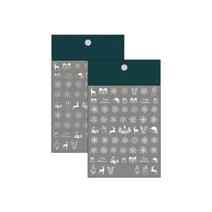 3D embossed Christmas nail stickers with white snowflakes and reindeer designs