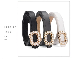 Detail of slim leather belts for women with pearl and crystal encrusted oval buckles