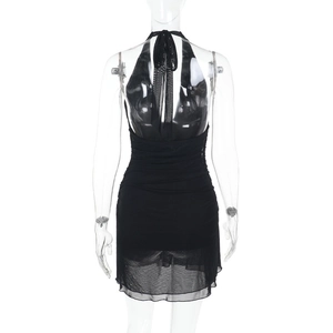 Detail showing backless design and sheer mesh patchwork on black mini dress