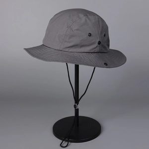 Detail view of quick-dry grey hiking hat featuring black metal breathable eyelets
