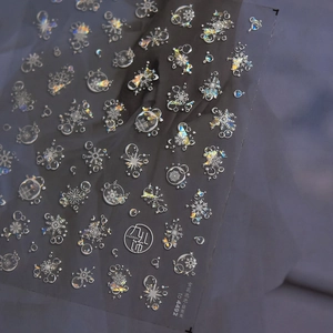 Detailed view of 5D embossed snowflake and bubble nail art stickers with shell luster finish