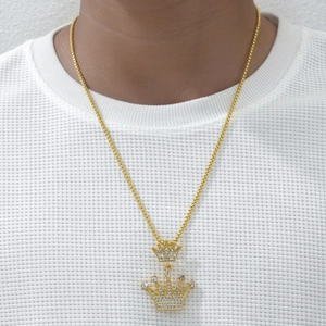 Hip hop style gold crown pendant necklace with sparkling crystals on white waffle t-shirt
