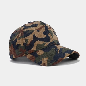 Macro detail of camouflage corduroy baseball cap showing textured fabric and stitching