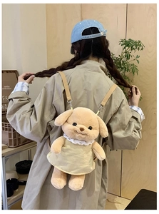 Detail of plush dog backpack featuring adjustable straps and elegant white lace collar