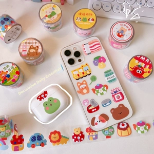 Detail of cute bear cartoon stickers and washi tape on phone case and desk accessories