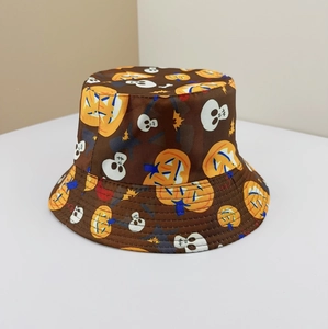 Detail shot of a brown Halloween bucket hat with pumpkin and skull print patterns