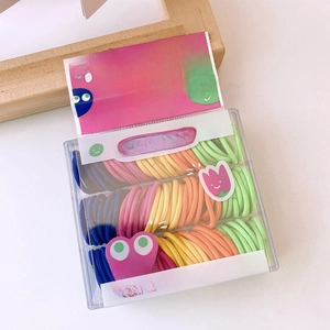 Macro detail of colorful seamless hair ties neatly organized in a clear storage box