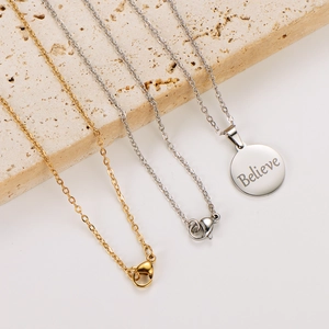 18k gold and silver stainless steel necklace with round 'Believe' engraved pendant