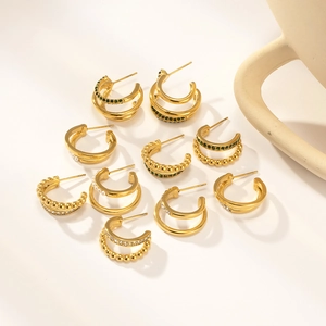 Detailed collection of nine 18K gold plated stainless steel hoop earrings with gems