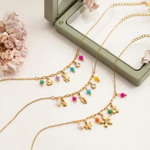 Detailed shot of 18K gold plated necklaces featuring colorful beads and animal charms