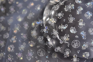Macro detail of holographic snowflake nail stickers with pearlescent laser finish
