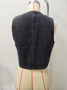 Detailed back view of vintage washed black denim vest featuring vertical seam and distressed texture