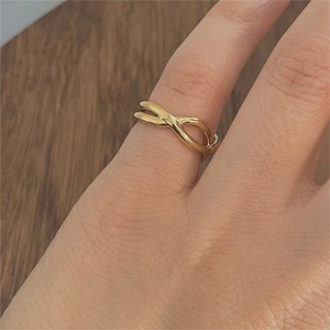 Minimalist 925 sterling silver infinity cross ring in gold finish worn on finger