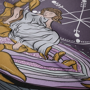 Close-up of tapestry fabric showing detailed Scorpio zodiac print and fine woven texture