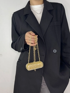 Luxurious gold crystal encrusted lipstick-shaped mini crossbody bag with chain strap