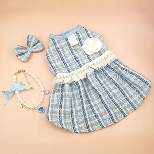 Detail view of blue tweed pet dress set with lace hem, bow hair clip, and pearl necklace