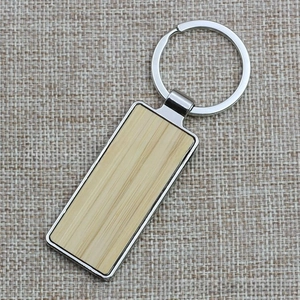 Detailed macro view of rectangular bamboo inlay within a polished metal keychain frame